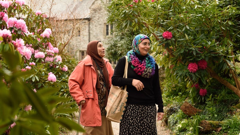 Visitors exploring the garden in spring at Cotehele, Cornwall